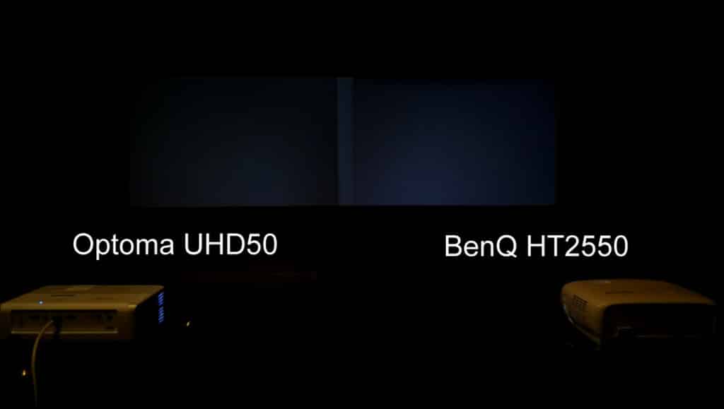 0 IRE, or “Pure Black” comparison. The Optoma on the left has the slightly better black. Note: Normally this is tested with all lights off but shown here with some light to show difference. Also their is a slight brighter area near the center caused by the overlapping of the surround borders around each image on this level of projector.