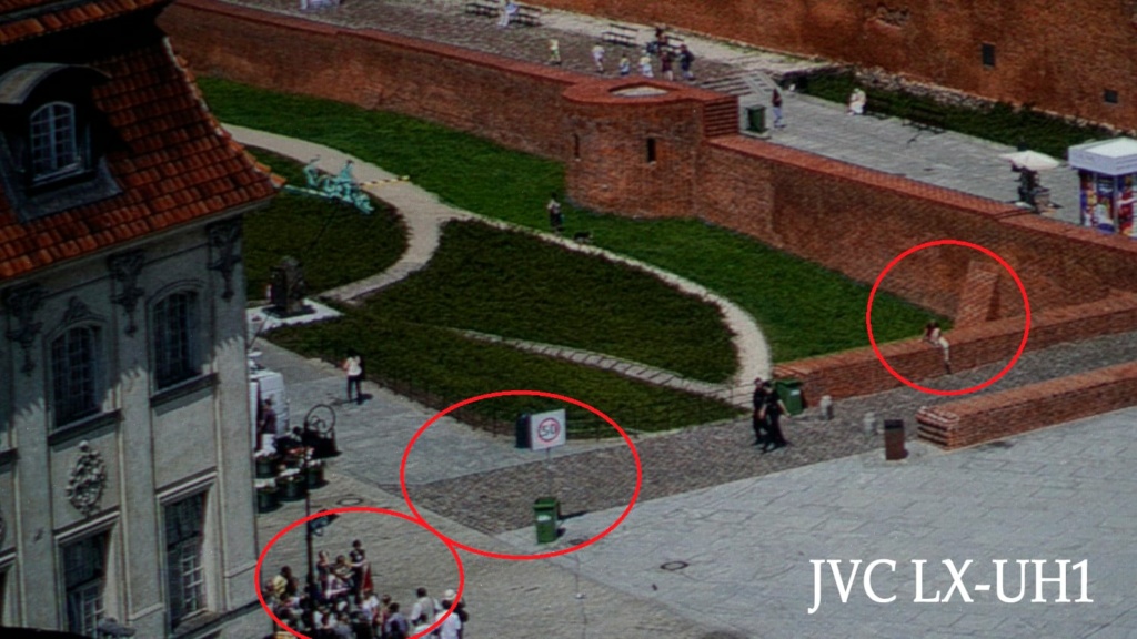 Better- Here the JVC shows slightly more actual detail in the bricks, pavement and people. Note: the JVC image was reversed to make comparisons easier.